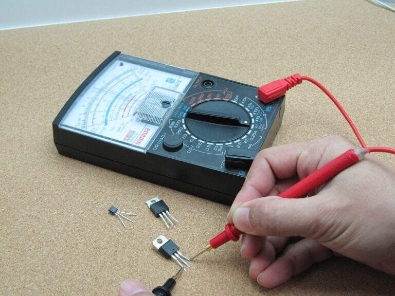 a close up of an electrical fault finding device being used on a small component