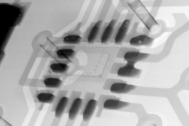 An x-ray image take of the inside of an electronics circuit board showing all the internal components