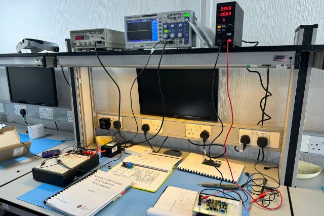 a work desk set up for an electronics skills course on fault finding