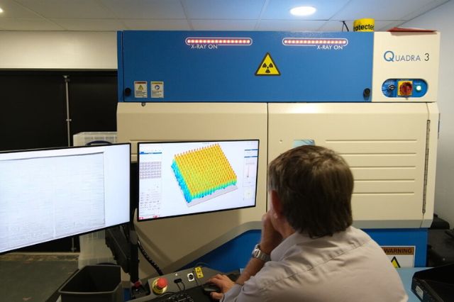 a master IPC trainer looking at the monitor of an x-ray machine to inspect a PCB