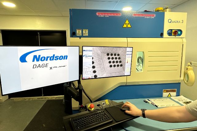 The Electronics Group non destructive x-ray testing machine being used with images of components on the screens 