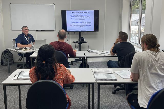 an classroom at the electronics group with students facing the trainer during an IPC CID course