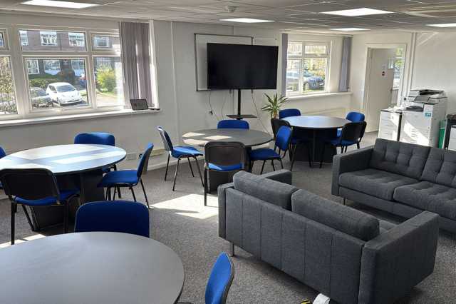 our new break room at the electronics group Leeds, with a sofa area and tables and chairs with a screen on the wall