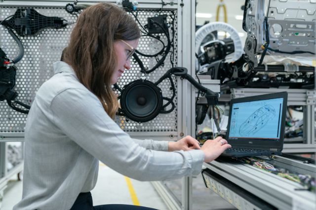 an engineer sat in a lab working from a laptop, representing women in engineering