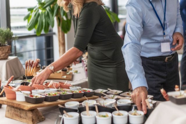 event attendees at a free buffet gettign lunch