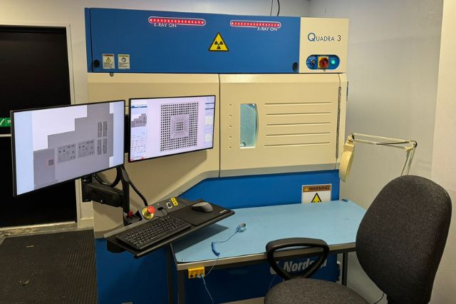 an electronics nin destructive x-ray machine with screens showing x ray images of pcbs